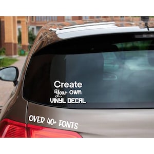 May include: A grey car with a white vinyl decal on the rear window that says "Create Your Own Vinyl Decal" and "Over 40+ Fonts".