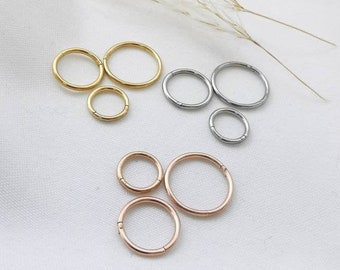 1 pair of mini piercing hoop earrings in gold, silver and rose made of stainless steel. Small hoop earrings in gold as a ring for the helix, ear or nose. Gift