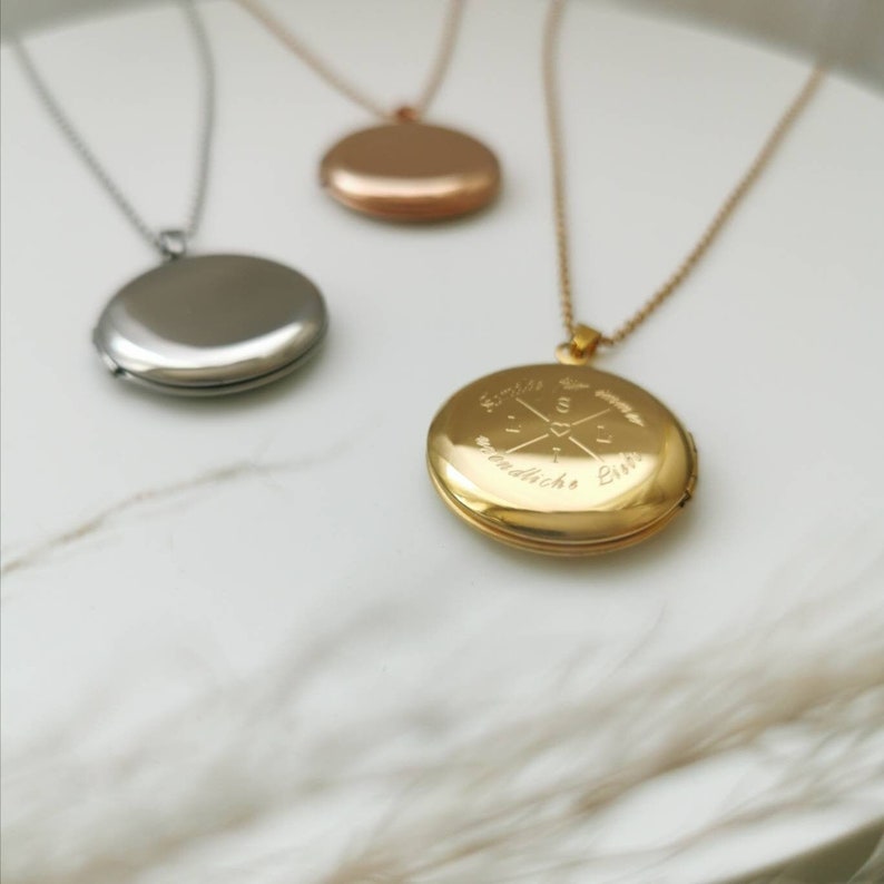 May include: Three silver locket necklaces, one with a plain silver locket, one with a rose gold locket, and one with a gold locket engraved with "Forever and always" and a compass design.