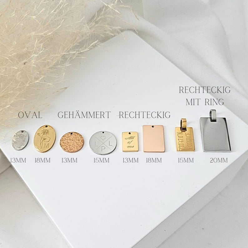 May include: Assortment of metal tags in various shapes and sizes, including oval, hammered round, and rectangular. The tags are made of silver, gold, and rose gold. The tags are labelled with their dimensions in millimetres.