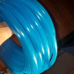 May include: A stack of bright blue flexible tubing, likely for crafts or DIY projects.