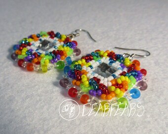 May include: A pair of rainbow beaded earrings with a clear square crystal in the center. The earrings are made with small seed beads in a variety of colors, including red, orange, yellow, green, blue, purple, and white.