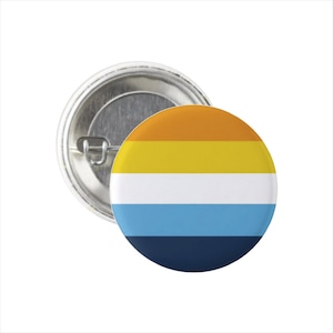 May include: A round button with a horizontal striped design. The stripes are orange, yellow, white, light blue, and dark blue.