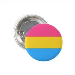 May include: A round button with a pansexual pride flag design. The flag has three horizontal stripes: pink, yellow, and blue.