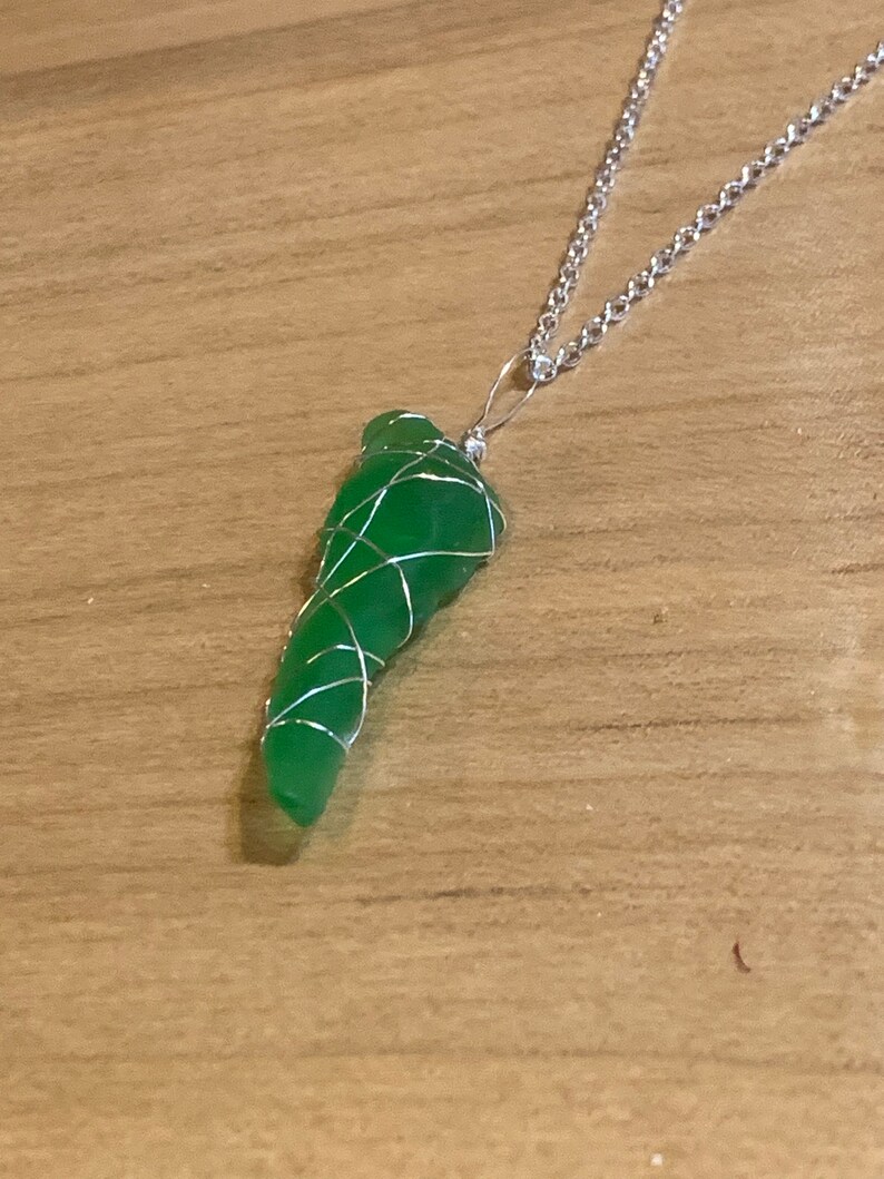 Green Beach Glass Wrapped In Silver Colored Wire