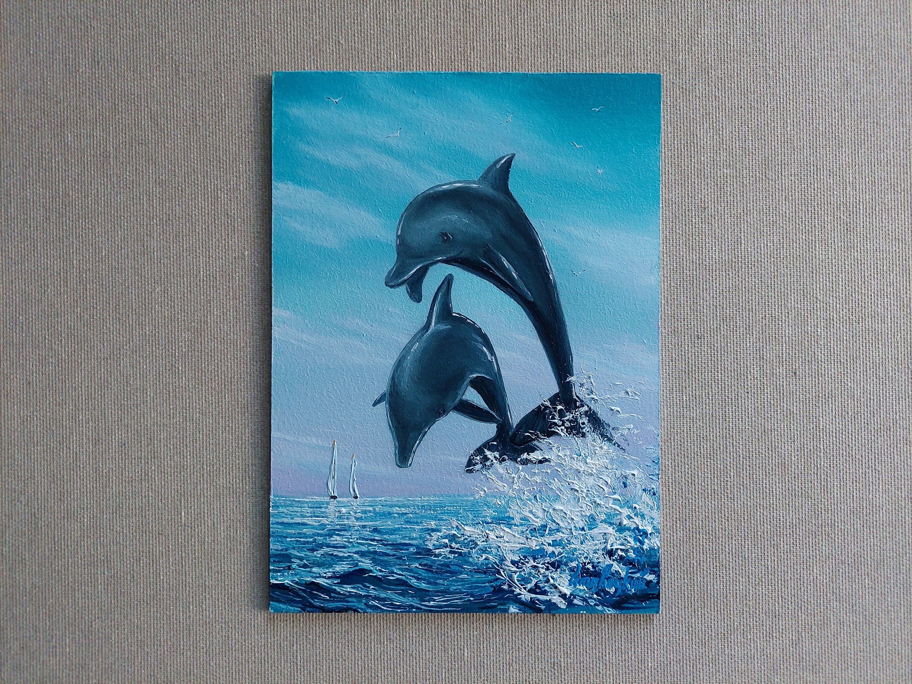 イルカの油絵 イルカの油絵。イルカのジャンプアート。澄み切った青空を背景に、青い