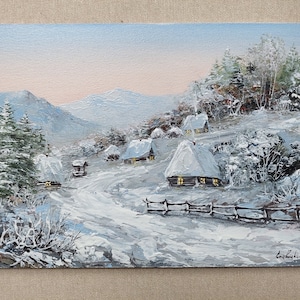 Winter village on the snow covered mountains art. Snowy wooden huts, waterwell and a stack of hay in winter season landscape oil painting