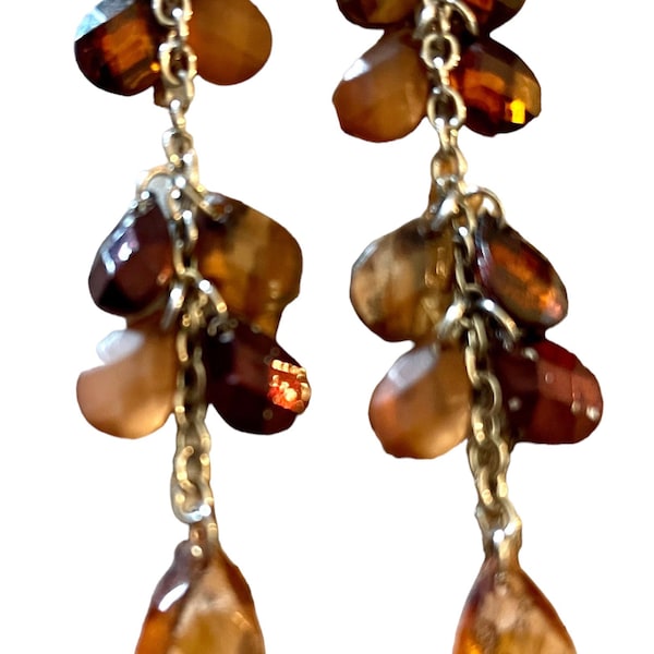 Long dangle earrings with small clusters and a bottom teardrop bead of amber/garnet