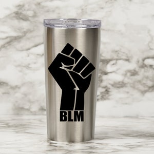 May include: A stainless steel tumbler with a black raised fist and the text "BLM" printed on the side.