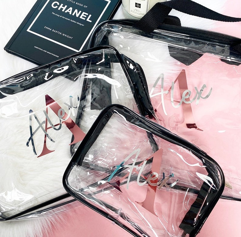 May include: Three clear plastic zippered pouches with black trim and rose gold lettering. The pouches are labeled "Alex" in a cursive font.