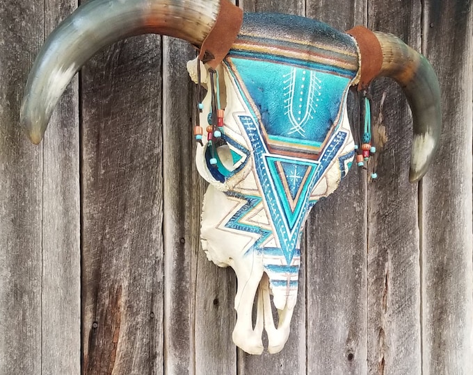 SOLD. This item has been sold.      Beautiful very large symmetrical hand painted real bull skull.