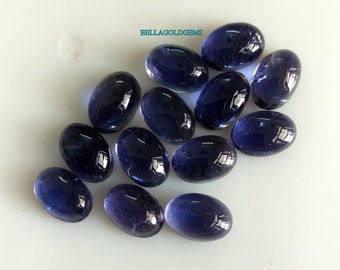 May include: A group of 12 oval-shaped, dark blue gemstones. The gemstones are smooth and polished, with a slight shimmer.