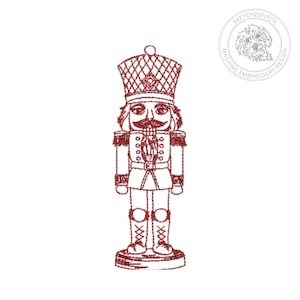 May include: A red machine embroidery design of a nutcracker figure featuring a tall hat with a cross-hatched pattern, a jacket with buttons, and tall boots. The design includes a circular logo in the top right corner with the text SKETCH2STITCH MACHINE EMBROIDERY DESIGN and an illustration of a dog.