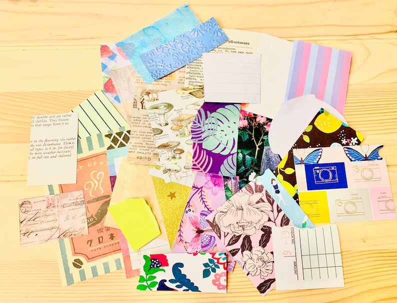 Peut inclure: Un ensemble de papiers d&eacute;coup&eacute;s aux motifs color&eacute;s, comprenant des motifs floraux, g&eacute;om&eacute;triques et abstraits. Certains papiers comportent du texte, notamment "Guide" et "70ネ".