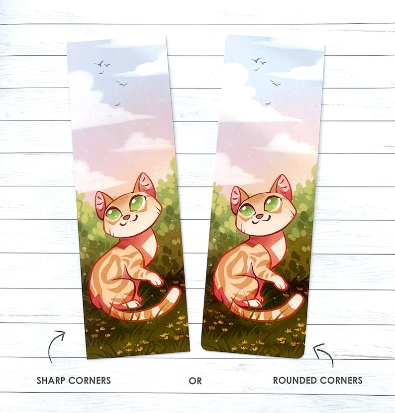 May include: A bookmark featuring a cartoon cat with orange and white fur, green eyes, and a pink nose. The cat is sitting in a field of green grass with yellow flowers. The background is a soft pink and blue sky with white clouds. The bookmark is available with either sharp or rounded corners.