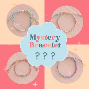 May include: Four colorful friendship bracelets with a light blue cloud with the text "Mystery Bracelet ???" in the center.