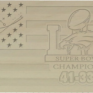 May include: A wooden plaque featuring an American flag design and a football helmet. The plaque reads "Super Bowl Champions 41-33".