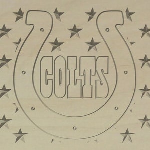 May include: A wooden sign featuring a horseshoe and the word "COLTS" in a stylised font. The horseshoe is encircled by a ring of stars.