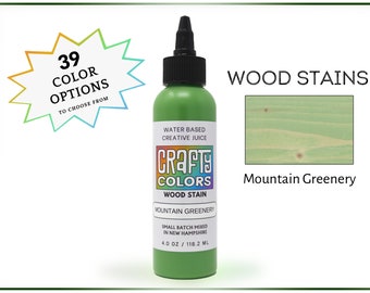 May include: A 4-ounce bottle of Mountain Greenery wood stain by Crafty Colors. The bottle is green and has a white label with the company logo and product information. The stain is water-based and small batch mixed in New Hampshire.
