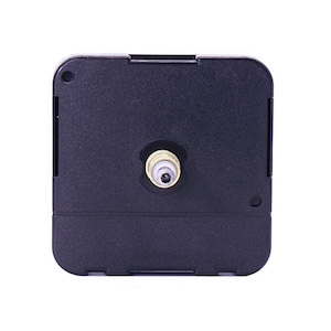 May include: A black clock movement with a gold-colored shaft. The movement is designed for use in a clock.