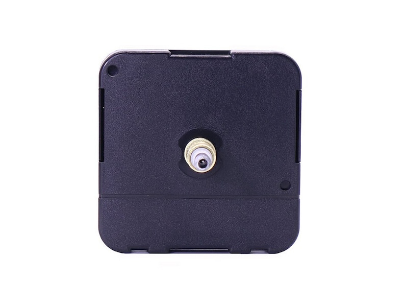 May include: A black clock movement with a gold-colored shaft. The movement is designed for use in a clock.