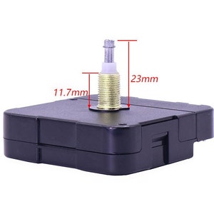 May include: A black clock movement with a silver and gold shaft. The movement measures 11.7 mm wide and 23 mm tall.