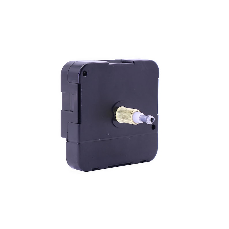 May include: Black clock movement with a gold-colored shaft and a white plastic tip. The movement is designed for use in a clock.