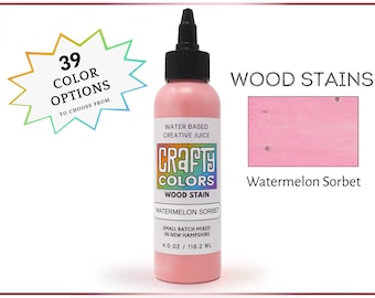 May include: A 4 ounce bottle of watermelon sorbet wood stain by Crafty Colors. The bottle is pink and has a white label with the company name and product information. The stain is water-based and small batch mixed in New Hampshire.