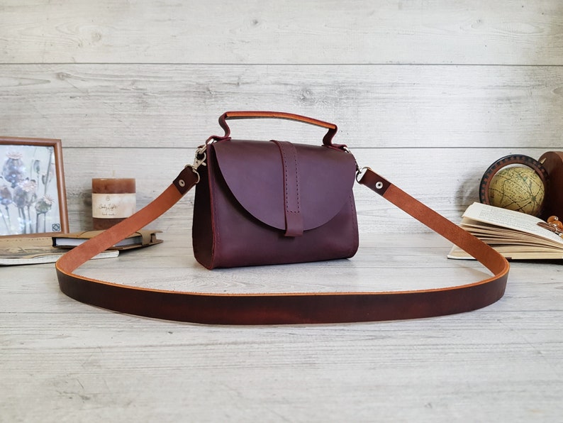 Handmade minimalist small leather purse with a removable crossbody / shoulder strap and handle. The handbag closes with a flap on a magnetic clasp. The bag is available in more than 10 colors. Can be personalized. Cute gift for her.