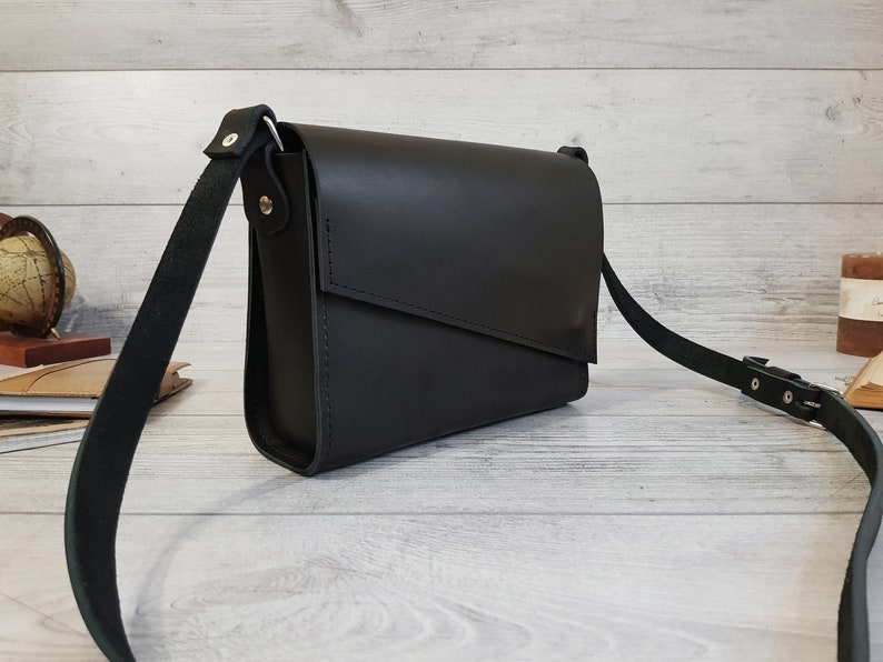 Handmade minimalist small womens leather purse with a crossbody / shoulder strap. The handbag closes with a diagonal flap on magnetic clasps. The bag is available in more than 10 colors. Can be personalized. Cute gift for her.