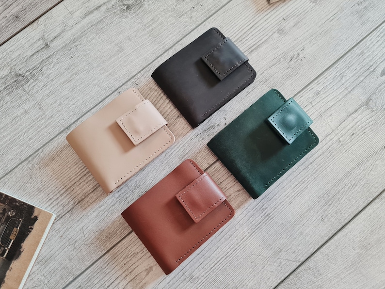 Handmade minimalist womens / mens leather bifold wallet. Closes with on a button. Has 1 compartment for bills and 6 slots for cards. 2 hardware colors are available. Comes in more than 10 colors. Personalized cute gift for her, him.
