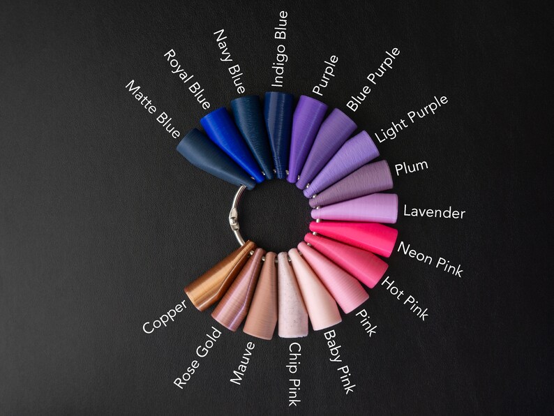 May include: A color chart with 18 different shades of blue, purple, pink, and copper. The colors are arranged in a circle, with the names of each color printed below.