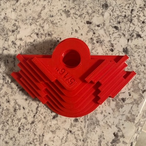 May include: A set of six red plastic corner miter jigs, stacked on top of each other. The jigs are labeled "91/8".