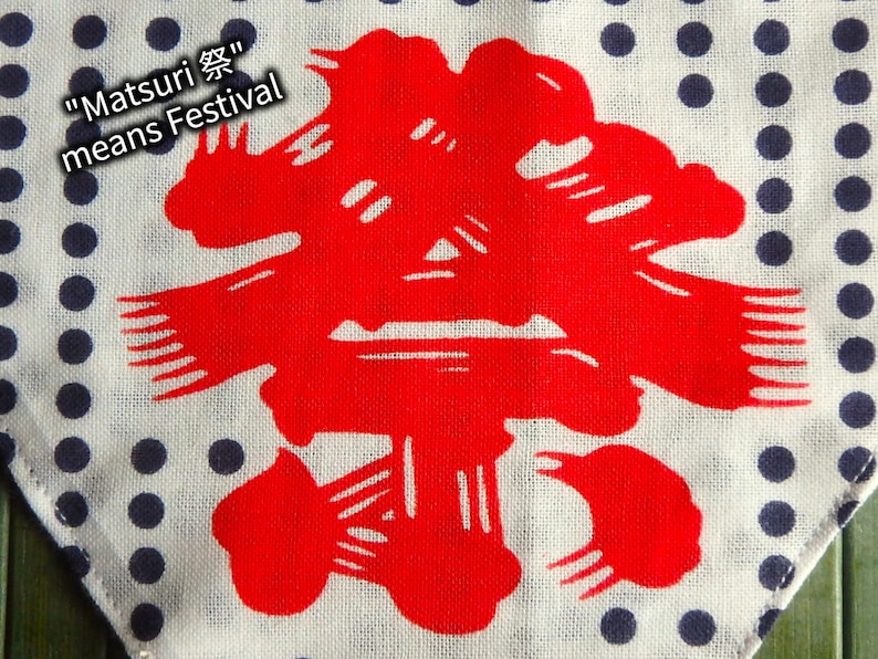 May include: A white fabric with a blue polka dot pattern. A red Japanese kanji character is centred on the fabric. The text "Matsuri 祭" means Festival.