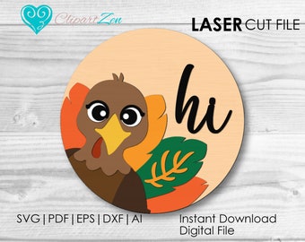 May include: A round, orange, green, and brown digital cut file featuring a cartoon turkey with the word "hi" in black script. The file is for laser cutting.