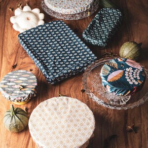 May include: Assortment of reusable food wraps in various patterns and colours. The wraps are made of fabric and are designed to cover bowls, plates, and other containers to keep food fresh.