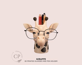 May include: A giraffe-shaped pen and glasses holder, 3D printed in beige with black spots. The giraffe wears round black glasses and holds pencils. The text "GIRAFFE 3D PRINTED GLASSES AND PEN HOLDER" is below the giraffe.