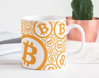 May include: White ceramic coffee mug with a repeating pattern of orange Bitcoin symbols. The mug has a curved handle and a cylindrical shape. The Bitcoin symbols are in various sizes and orientations, creating a dynamic design.