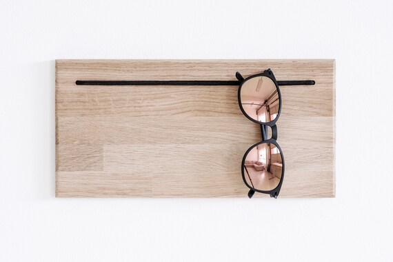 8 benefits of a spectacle holder  Wooden glasses holder, Eyewear store  design, Eyewear display