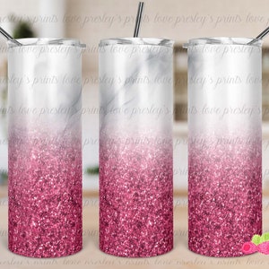 May include: Three stainless steel tumblers with a white marble design and a pink glitter ombre effect. The tumblers have lids and straws.