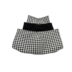 May include: Three black and white gingham fabric face masks. The top mask is folded in half and the bottom two masks are unfolded. The masks are made of a soft, breathable fabric.