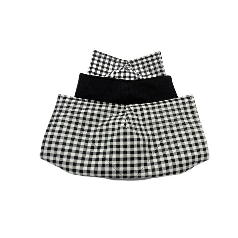 May include: Three black and white gingham fabric face masks. The top mask is folded in half and the bottom two masks are unfolded. The masks are made of a soft, breathable fabric.