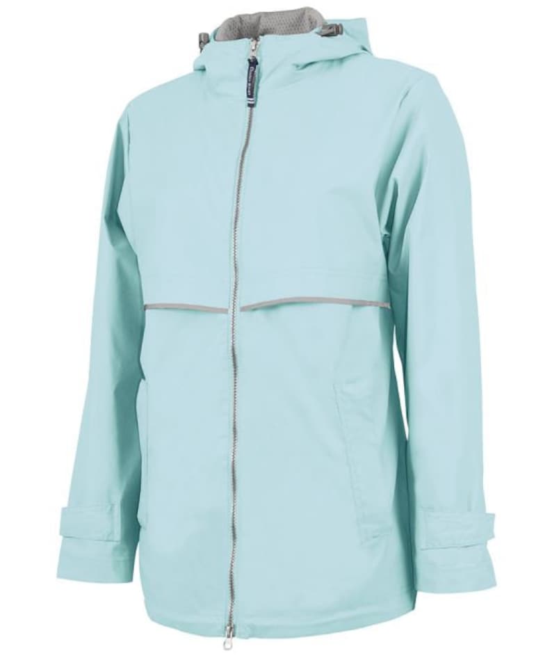 May include: A light blue hooded jacket with a zipper closure and a reflective strip across the chest.