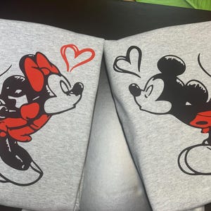 couples matching valentines day hoodie with Disney design and initials on sleeve.
