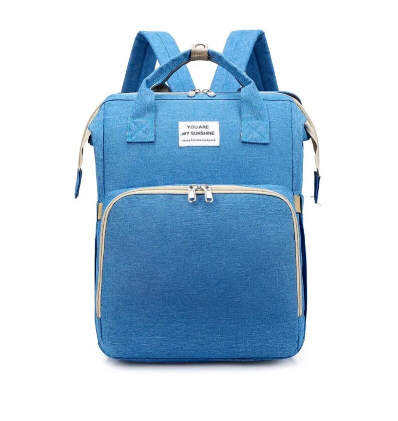 May include: A blue diaper bag backpack with a zippered pocket and the text "You are my sunshine" on the front.