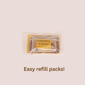 May include: A clear plastic bag containing a small gold packet with the text "MAKER HOUSE" and the words "Organic Wheat Grass Seeds" and "For 1 Cup Size Planter". The bag also contains a small packet of wheat grass seeds.