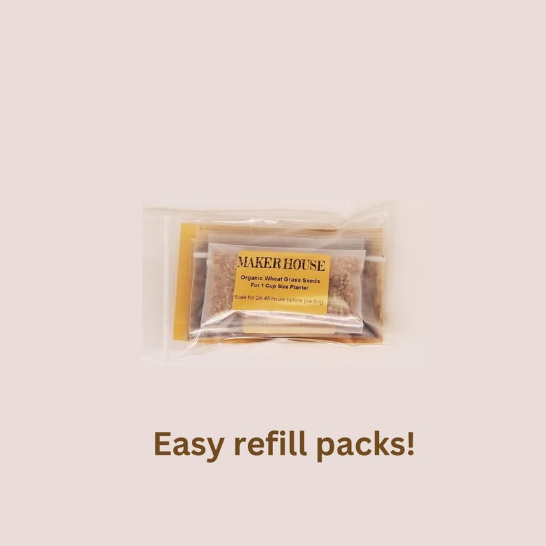 May include: A clear plastic bag containing a small gold packet with the text "MAKER HOUSE" and the words "Organic Wheat Grass Seeds" and "For 1 Cup Size Planter". The bag also contains a small packet of wheat grass seeds.