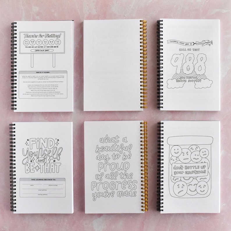 six spiral-bound notebooks with various designs and text on their covers.