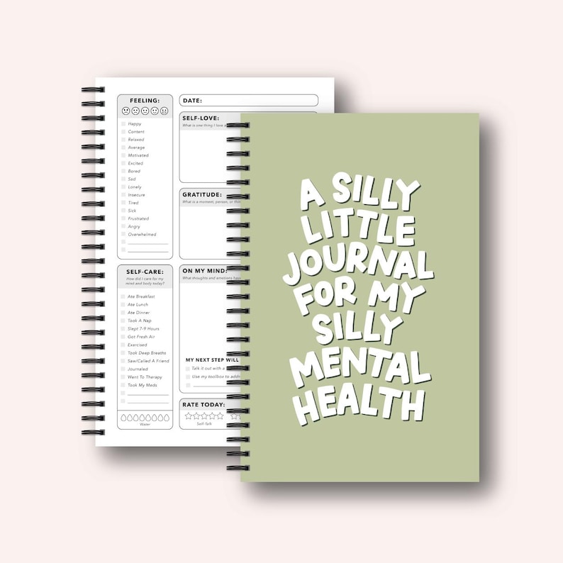 a spiral-bound notebook with a green cover, displaying a list of self-care activities and a title that reads "A SILLY LITTLE JOURNAL FOR MY SILLY MENTAL HEALTH".