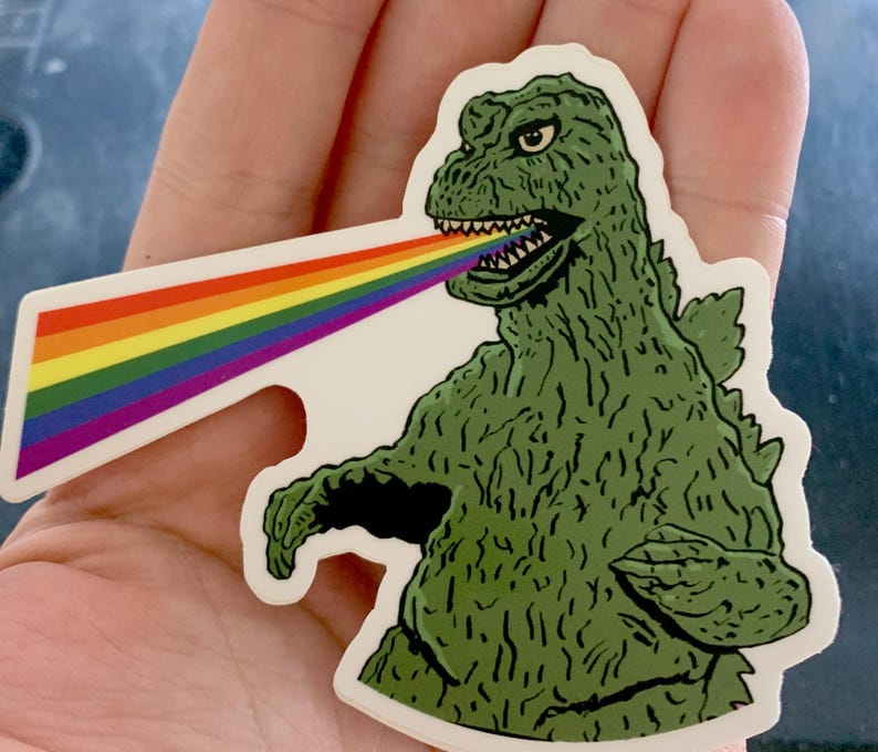 My Gayzilla sticker is an illustration of Godzilla shooting rainbows instead of radioactive rays out of his mouth.